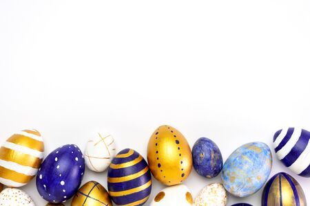 Happy Easter. Frame for text made of easter eggs trendy colored classic blue, white and golden on white. Minimal style, top view, flatlay, copy spaceの写真素材