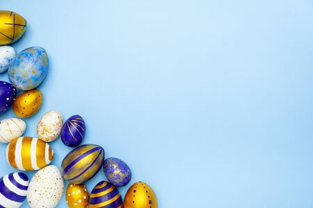 Happy Easter. Frame for text made of easter eggs trendy colored classic blue, white and golden on blue. Minimal style, top view, flatlay, copy spaceの写真素材