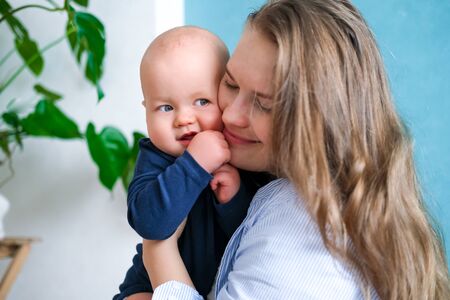Happy baby. Little cutest chubby caucasian white infant child looking and smiling at camera on...