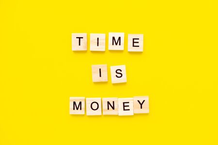 Words Time is money on yellow background. business concept.の写真素材