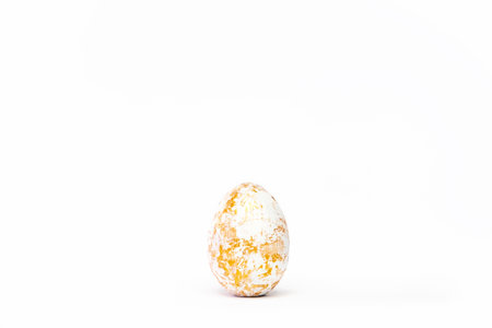 Minimal easter card. One easter trendy golden decorated egg on white background. Copy space for...