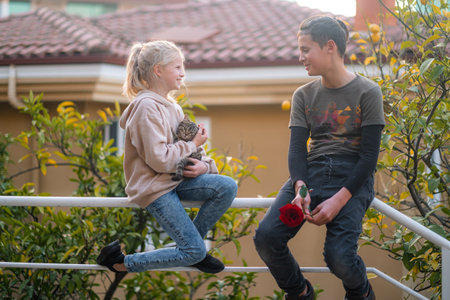 Portrait young teens couple, boy and girl hugging on street, first dating, flower and kids love.