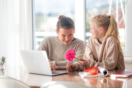 First love, young teens lovers couple studying laptop at home, boy and girl doing homework, first...