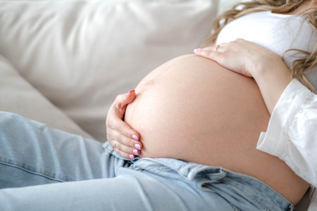 pregnant woman with big belly advanced pregnancy resting sitting on sofa at home.Healthy pregnancy...