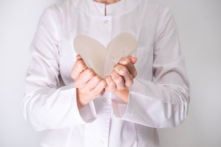 doctor holding breast enlargement implant in hands, heart shape made from implants, plastic surgery, beauty enhancement, medical Mammoplasty, mastopexyの写真素材