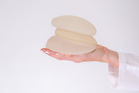 doctor holding breast enlargement implant in hands, plastic surgery concept, beauty enhancement, medical Mammoplasty and plastic surgery, mastopexyの写真素材