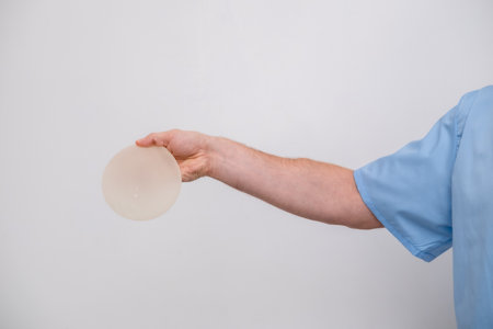 doctor holding breast enlargement implant in hands, plastic surgery concept, beauty enhancement, medical Mammoplasty and plastic surgery, mastopexyの写真素材