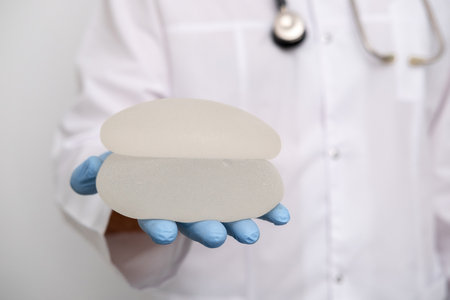 doctor holding breast enlargement implant in hands, plastic surgery concept, beauty enhancement, medical Mammoplasty and plastic surgery, mastopexyの写真素材