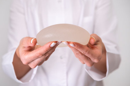 doctor holding breast enlargement implant in hands, plastic surgery concept, beauty enhancement, medical Mammoplasty and plastic surgery, mastopexyの写真素材