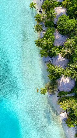 Tropical white sand beach with calm turquoise water and palm trees under blue sky, serene atmosphere...