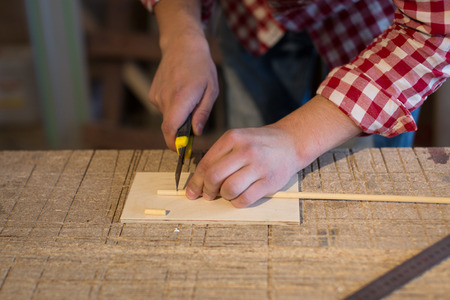 joiner cutter cuts a wooden stick made of wood toys