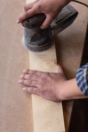 Carpenter hands Using Electric Sander.の写真素材