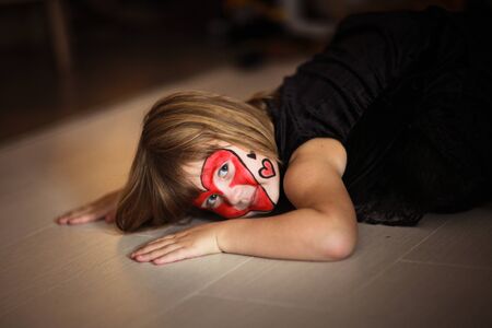 face painting  girl  on a dark background, the concept of  holiday on  dark backgroundの写真素材