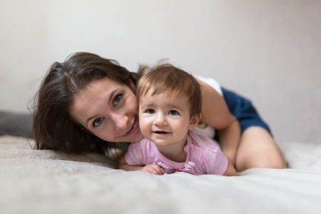 happy loving family. mother playing with her baby in the bedroom. Cosy house, lifestyle, selective focus, toningの写真素材