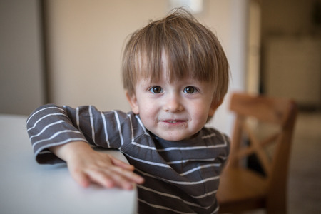 dirty blonder Toddler boy  in  kitchen  childhood, real interior, toning, lifestyle, soft focus