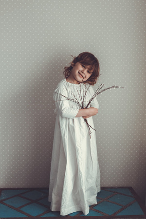 tender girl in a nightgown retro with sprigs of willow, toningの写真素材