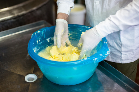 production of butter, working hand washed the butter in a basin, a small businessの写真素材