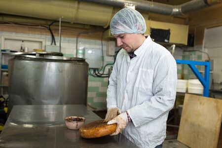 production of cheese in the dairy, work mixes lubricates coffee head Monterey Jack cheese