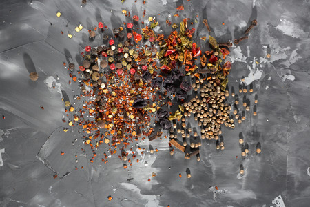 Scattered Spilled mixture of spices on a gray concrete background