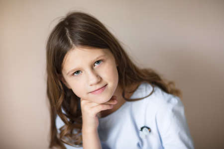 Charming European tender teen girl with long hair, close-up portrait, pastel colors