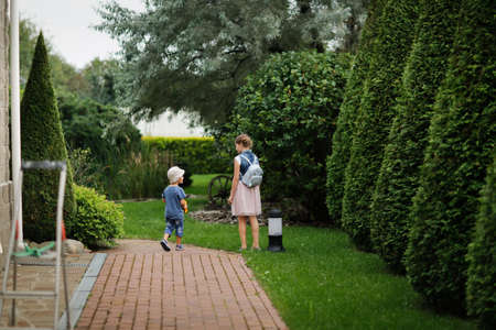 brother and sister sibling children walking in the garden, landscape and topiary art, English garden...