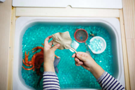 Children's hands play with toys in the bathtub. Selective focus. Kid.の写真素材