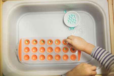 Child playing with plastic toys. Early development and education.の写真素材