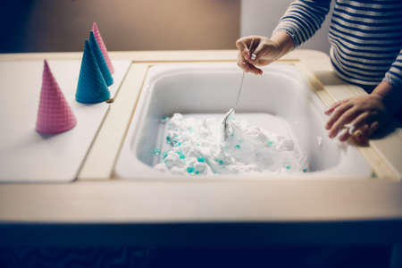 A woman washes her hands with soap and water.の写真素材