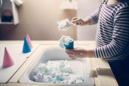 Close-up of woman washing clothes with detergent in the bathroomの写真素材