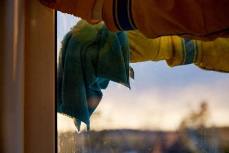House cleaning in spring. Washing windows. Household chores, a man cleans his house.の写真素材