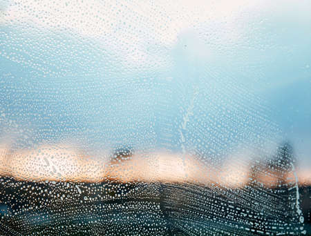 House cleaning in spring. Washing windows. Household chores, a man cleans his house.の写真素材