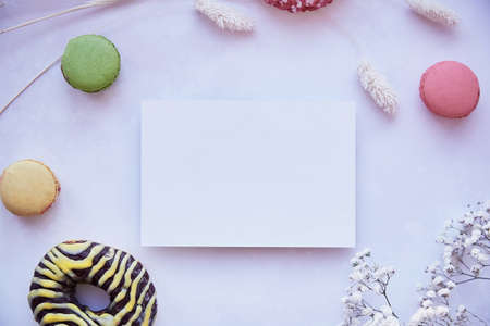 Macarons, gypsophila and lagurus ovatus grass and gift card. Mothers Day greeting card concept.