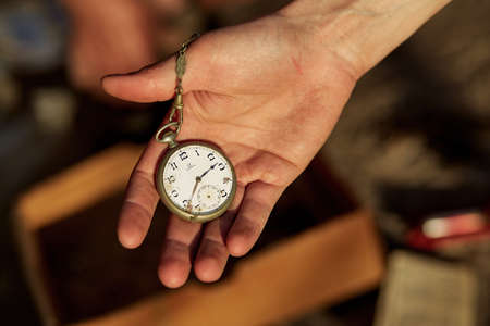 Vintage clock in the hand. Intarnational Museum Day concept. Top viewの写真素材