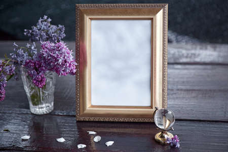 Scandinavian interior. Gorgeous mock up frame with shadows lilac flowers. Office table concept....
