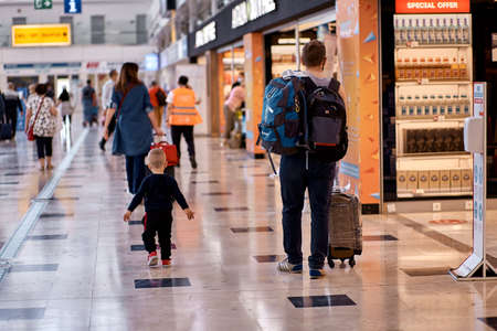 Antalya, Turkey - May 19: Father with luggage and son walking at the airport. Blurred background. Vacation on Fathers Day concept. High quality photoのeditorial素材