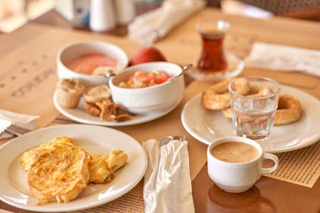 All inclusive breakfast: a large assortment of food for different tastes: turkish tea, coffee omelets, yoghurts and fresh baked goods. Popular type of food service during the holiday season. High quality photo.の写真素材
