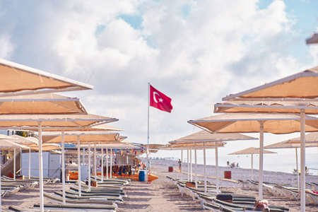 Kemer, Turkey - May, 21: Beach view of sunbeds, coast, sea on a bright sunny day. Turkish beach with...