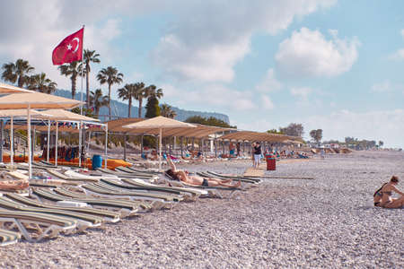 Kemer, Turkey - May, 21: Beach view of sunbeds, coast, sea on a bright sunny day. Turkish beach with Turkey flag. High quality photoのeditorial素材