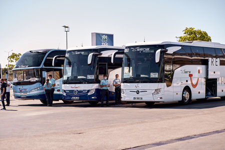 Antalya, Turkey - May 19: Kemer, Turkey - May 19, 05: Tourist modern buses parked at the airport waiting for tourists on a sunny day. People and passengers in masks. Summer vacations starts concept.のeditorial素材