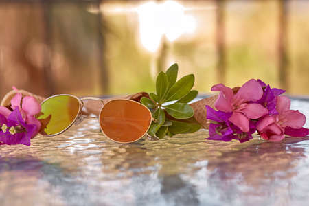 Surreal bright pink bougainvillea flowers in an ice cream cone and sunglasses. Summer vacation background. Copy space.の写真素材