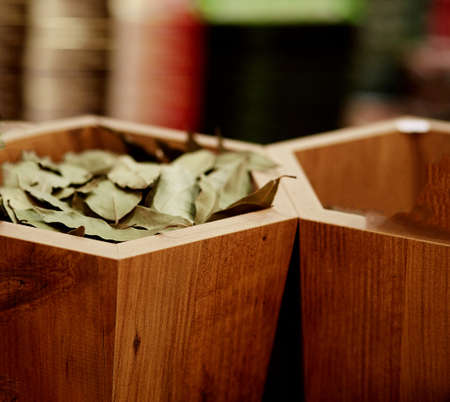 Seasoning dried bay leaf in a wooden box in a supermarket. high quality photoの写真素材