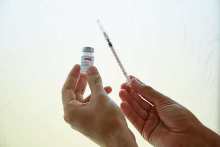 Kyiv, Ukraine - June 26, 2021: AstraZeneca vaccine. Vaccinations during coronavirus. Vaccine bottles effective in preventing Covid-19 infections. High quality photoのeditorial素材