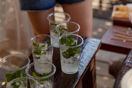 Young woman at a bachelorette party makes a mojito cocktail for the company. Preparation instructions. Step 3. High quality photoの写真素材