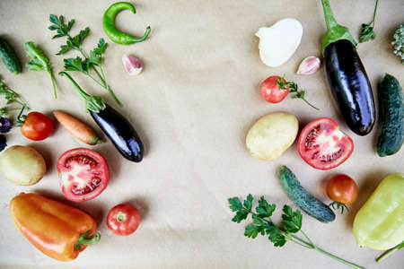 Vegetable frame: beet, basil, eggplant, parsley, bell pepper, hot pepper, potatoes, cucumber, carrots. Italian vegetable recipe. Veganism concept food. Top view, copy space. High quality photoの写真素材