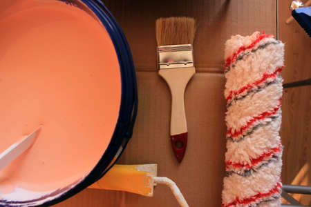 Preparing to paint the wall with brush, paint and roller brush. Top view. Home renovation. High quality photoの写真素材