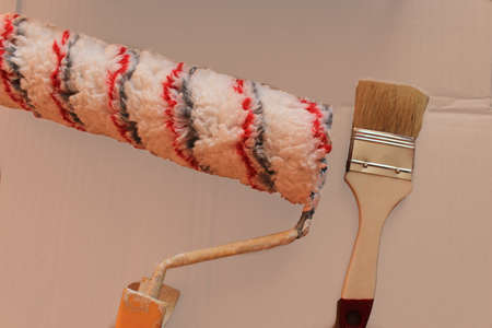 Preparing to paint the wall with brush, paint and roller brush. Top view. Home renovation. High quality photoの写真素材