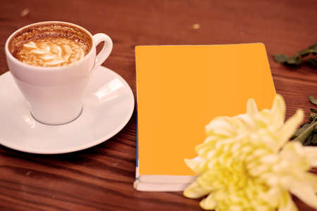Mock up book, coffee and flower. Autumn, morning coziness concept. High quality photo