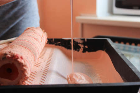 Preparing to paint the wall with brush, paint and roller brush. Top view. Home renovation. High quality photoの写真素材