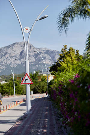 Right turn sign in front of mountain view and beautiful greenery. Modern road, turkish view. High quality photoの写真素材