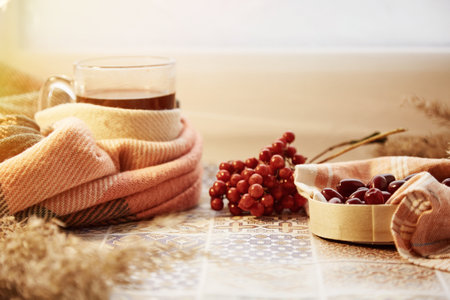 Natural healthy calming drink with dogwood berry. Autumn healthy food. Pastel colors with copy space. Healthy organic food. Vitamin tea. Home coziness, decorations table. High quality photoの写真素材